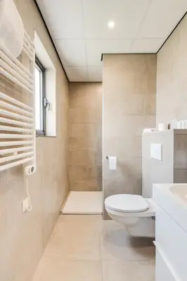 a bathroom with a toilet and a shower at Hotel Italia in Zelzate