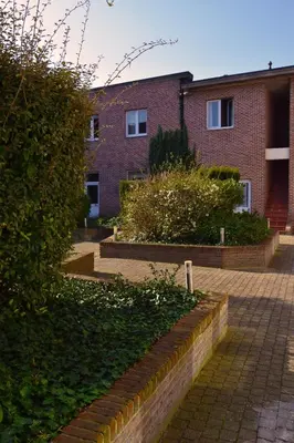 a brick building with stairs in front of it at Budget Flats Leuven in Leuven