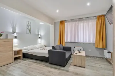a bedroom with a bed and a chair and a desk at Budget Flats Leuven in Leuven