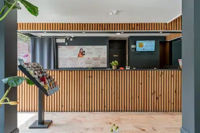 a display of wine bottles on a counter in a room at Sleep & Go Brussels South in Waterloo