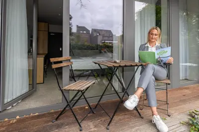 a woman sitting at a table with a laptop at Corbie Mol in Mol