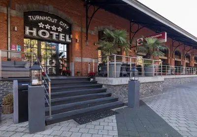 a hotel with stairs in front of a building at Turnhout City Hotel in Turnhout