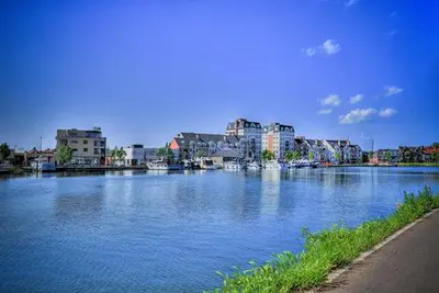 a large body of water with buildings in the background at Turnhout City Hotel in Turnhout