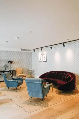 a living room with a couch and two chairs at Hotel FRANQ in Antwerp