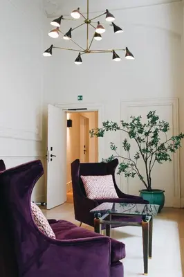 a living room with two chairs and a table at Hotel FRANQ in Antwerp