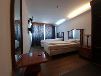 a hotel room with two beds and a mirror at SKY APART HOTEL - Hotel EUROCAP in Brussels