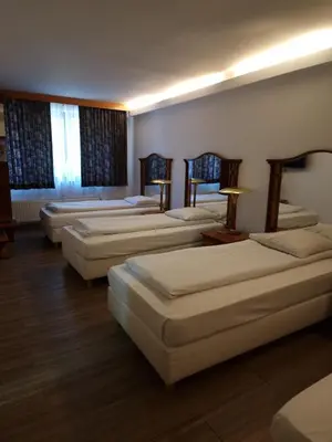 a row of beds in a room with wooden floors at SKY APART HOTEL - Hotel EUROCAP in Brussels