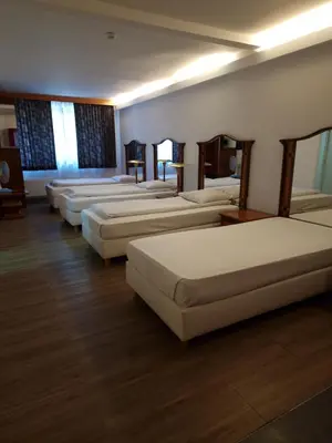 a row of beds lined up in a room at SKY APART HOTEL - Hotel EUROCAP in Brussels