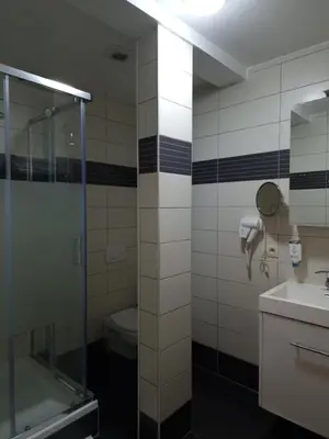 a bathroom with a glass shower and a toilet at SKY APART HOTEL - Hotel EUROCAP in Brussels