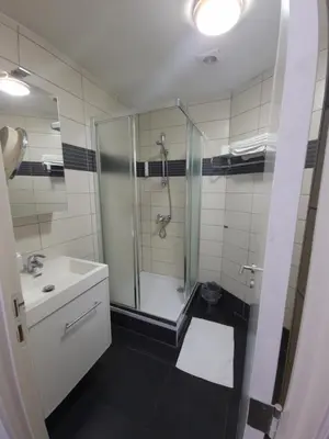 a bathroom with a shower and a sink at SKY APART HOTEL - Hotel EUROCAP in Brussels
