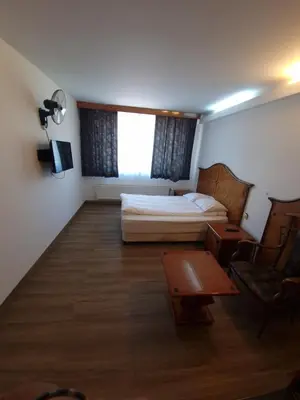 a bedroom with a bed and a table and a chair at SKY APART HOTEL - Hotel EUROCAP in Brussels