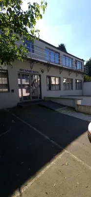 a building with a parking lot in front of it at SKY APART HOTEL - Hotel EUROCAP in Brussels
