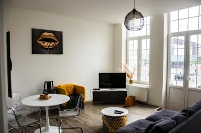 a living room with a couch and a table at Hotel Industrie in Leuven