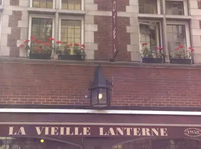 a building with potted plants on top of it at Hotel La Vieille Lanterne in Brussels
