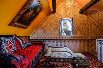 a living room with a red couch and a window at Hotel Mozart in Brussels
