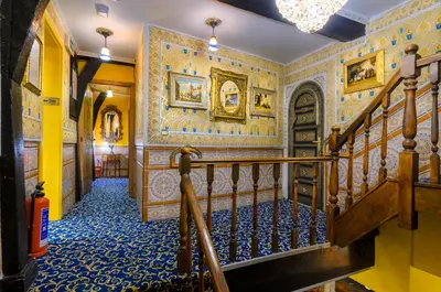 an ornate hallway with a staircase in a building at Hotel Mozart in Brussels