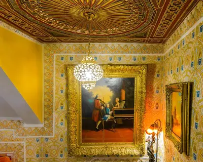 a room with a painting on the wall and a chandelier at Hotel Mozart in Brussels