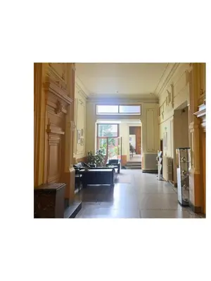 a large room with a large window and a living room at Institute Of Cultural Affairs in Brussels