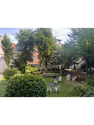 a group of tables and chairs in a yard at Institute Of Cultural Affairs in Brussels