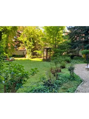a garden with green grass and trees and a pathway at Institute Of Cultural Affairs in Brussels