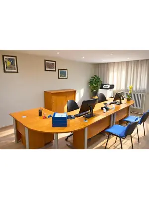 a meeting room with long wooden tables and chairs at Institute Of Cultural Affairs in Brussels