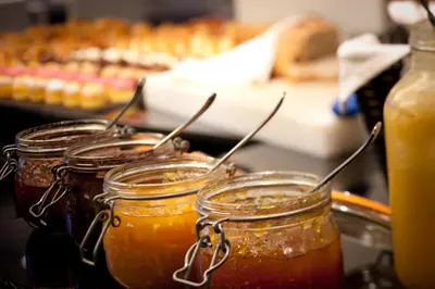 a group of jars of honey on a counter at YOOMA Urban Lodge in Brussels