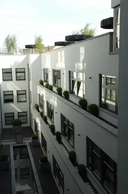 an apartment building with plants on the balconies at YOOMA Urban Lodge in Brussels