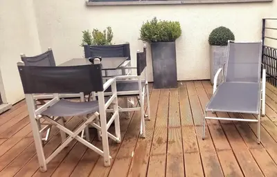 two chairs and a table and two chairs on a patio at YOOMA Urban Lodge in Brussels