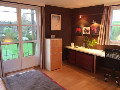 a home office with a desk and a window at Le Jardin Des Sources in La Hulpe