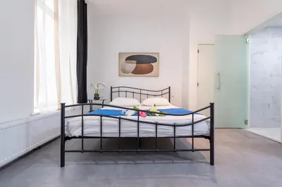 a bedroom with a bed in a room at Hotel Le Grand Colombier in Brussels