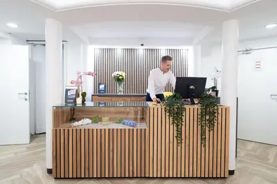 a man standing at a desk with a laptop at Hotel Abberdeen in Brussels