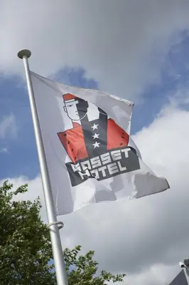 a white and orange flag flying in the sky at Gosset Hotel in Groot-Bijgaarden