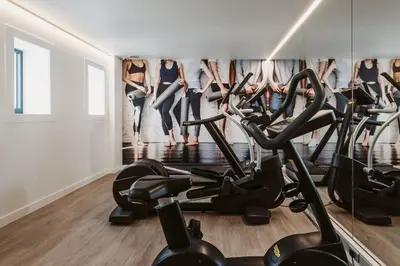 a gym with a row of treadmills at Serwir Hotel in Sint-Niklaas