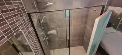 a shower with a glass door in a bathroom at Avalon Hotel in Overijse