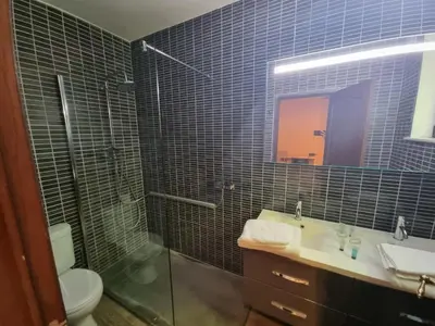a bathroom with a sink and a shower and a toilet at Avalon Hotel in Overijse