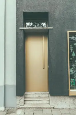 a yellow door on the side of a building at AP8 city & park apartement in Aalst