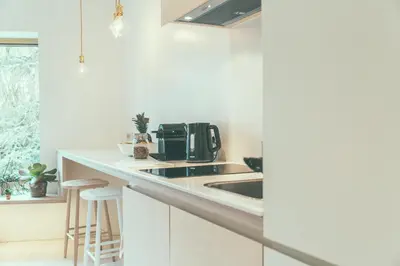 a kitchen with a sink and a coffee maker on a counter at AP8 city & park apartement in Aalst