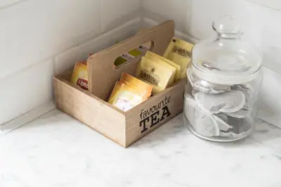 a wooden box sitting on a counter next to a jar at Cozy & Bright Apartment in Antwerp