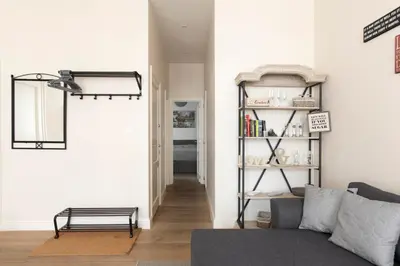 a living room with a couch and a book shelf at Cozy & Bright Apartment in Antwerp