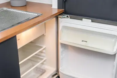 an open refrigerator with its door open at Simone's Kitchen B&B in Antwerp