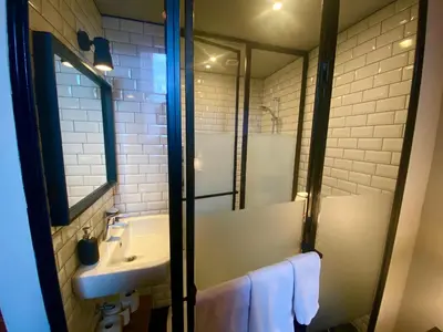 a bathroom with a sink and a mirror at Simone's Kitchen B&B in Antwerp