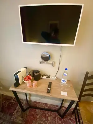 a small table with a television on top of it at Simone's Kitchen B&B in Antwerp