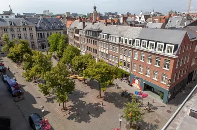 an aerial view of a city with buildings and trees at BANKS Antwerp in Antwerp