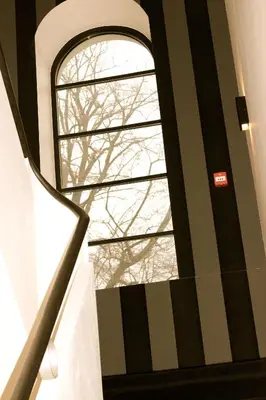 a stairway with a window in a building at The Hamptons Boutique Hotel in Ghent