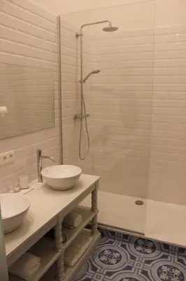 a bathroom with two sinks and a shower at The Hamptons Boutique Hotel in Ghent