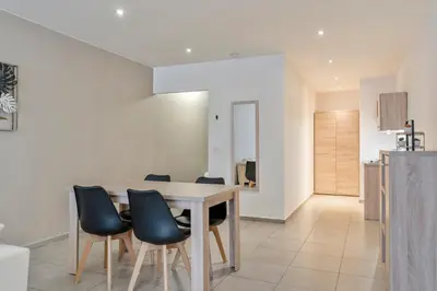 a kitchen and dining room with a table and chairs at Ambassador Suites Leuven in Leuven