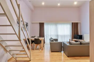 a living room with a couch and a table at Ambassador Suites Leuven in Leuven