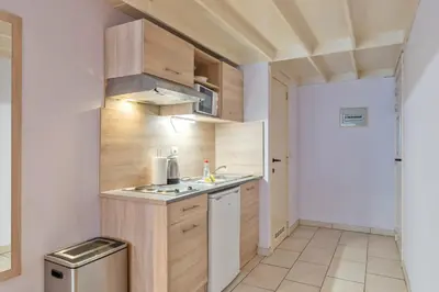 a small kitchen with a sink and a stove at Ambassador Suites Leuven in Leuven