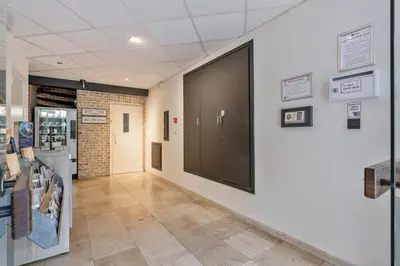 a hallway with a large screen on a wall at Ambassador Suites Leuven in Leuven