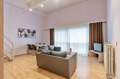 a living room with a couch and a table at Ambassador Suites Leuven in Leuven